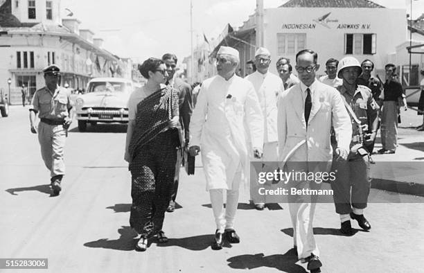 Prime Minister Nehru of India and his daughter Indira Gandhi walked from the meeting hall of the African Asian Conference to their hotel after one of...