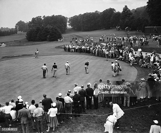 Big gallery and a trio of ace golfers , Claude Harmon, Tommy Bolt and George Fazio, watch Ben Hogan putt on the 18th hole during this afternoon's...
