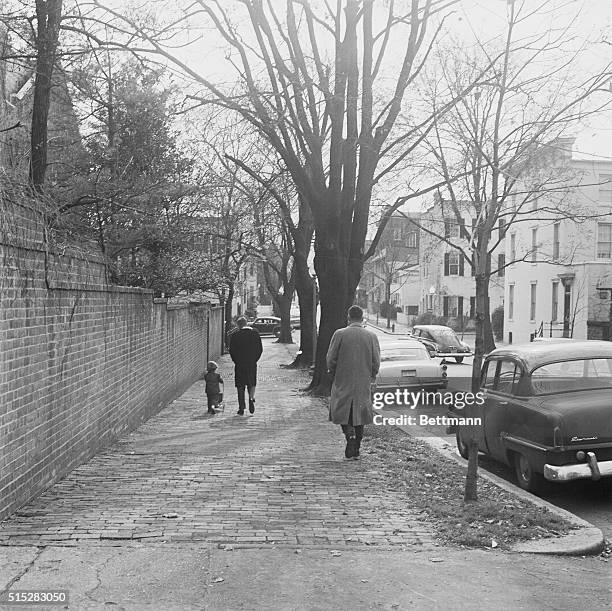 With a Secret Service man close by, President-elect John F. Kennedy takes daughter Caroline for a walk around the block near his Georgetown home...