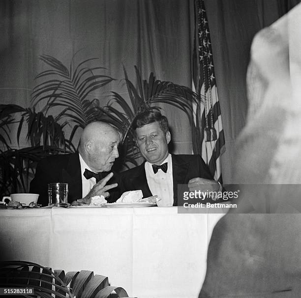 House Speaker Sam Rayburn chats with President John F. Kennedy at a birthday dinner for the president at the National Guard Armory in Washington, DC....