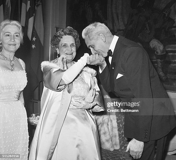 Courtesy Kiss. New York: Essaying a gentlemanly gesture, French Ambassador Armand Berard kisses the hand of Perle Mesta during the United States Ball...