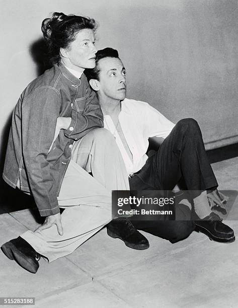 Katharine Hepburn and Robert Helpmann relax during a break in rehearsal during a series of Shakespearean plays they will be performing on a tour of...