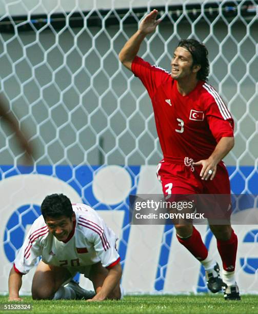 Turkey's Bulent Korkmaz celebrates his 9th minute goal as China's Yang Chen looks on,13 June 2002 at the Seoul World Cup Stadium in Seoul, during...