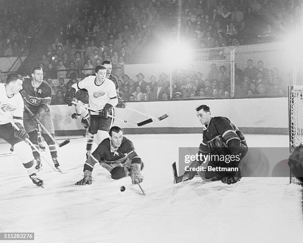 Loose Puck. . .Whose Puck? Detroit, Michigan: All eyes seem to be on the puck but no one owns it right now. Down on the ice are Canadiens' Butch...