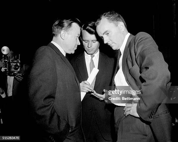 Walter Reuther, left, president of the UAW, goes into a huddle with Senate Rackets Committee Counsel Robert F. Kennedy, center, and Jack Conway,...