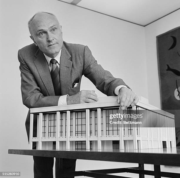 Architect Philip Johnson points out some of the features of the final plans on a model of the New York State Theater to be built at Lincoln Center....