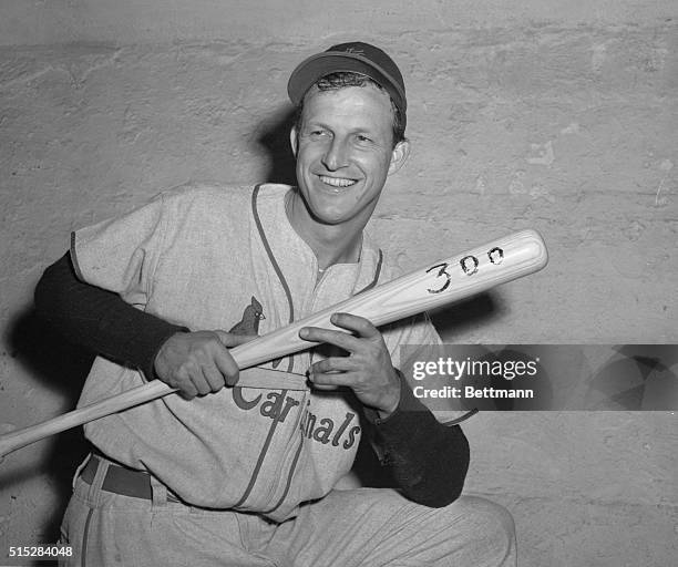 Stan's 300th Homer. Brooklyn, New York: Stan Musial of the St. Louis Cardinal's holds up the bat with which he poled the 300th home run of his...