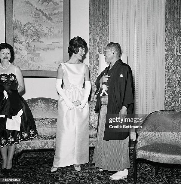 Mrs. Jacqueline Kennedy chats with Japanese Prime Minister Hayato Ikera as show arrives to attend a dinner given by the Prime Minister at the...