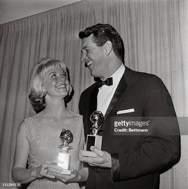 Honored as the "World Film favorites by the Hollywood Foreign press Association, Doris Day and Rock Hudson hold their Golden Globes as they pose for...