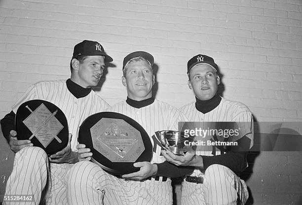 New York Yankee's award winners, Ralph Terry , Mickey Mantle , and Tom Tresh, display trophys received during the pre-game ceremonies at Yankee...
