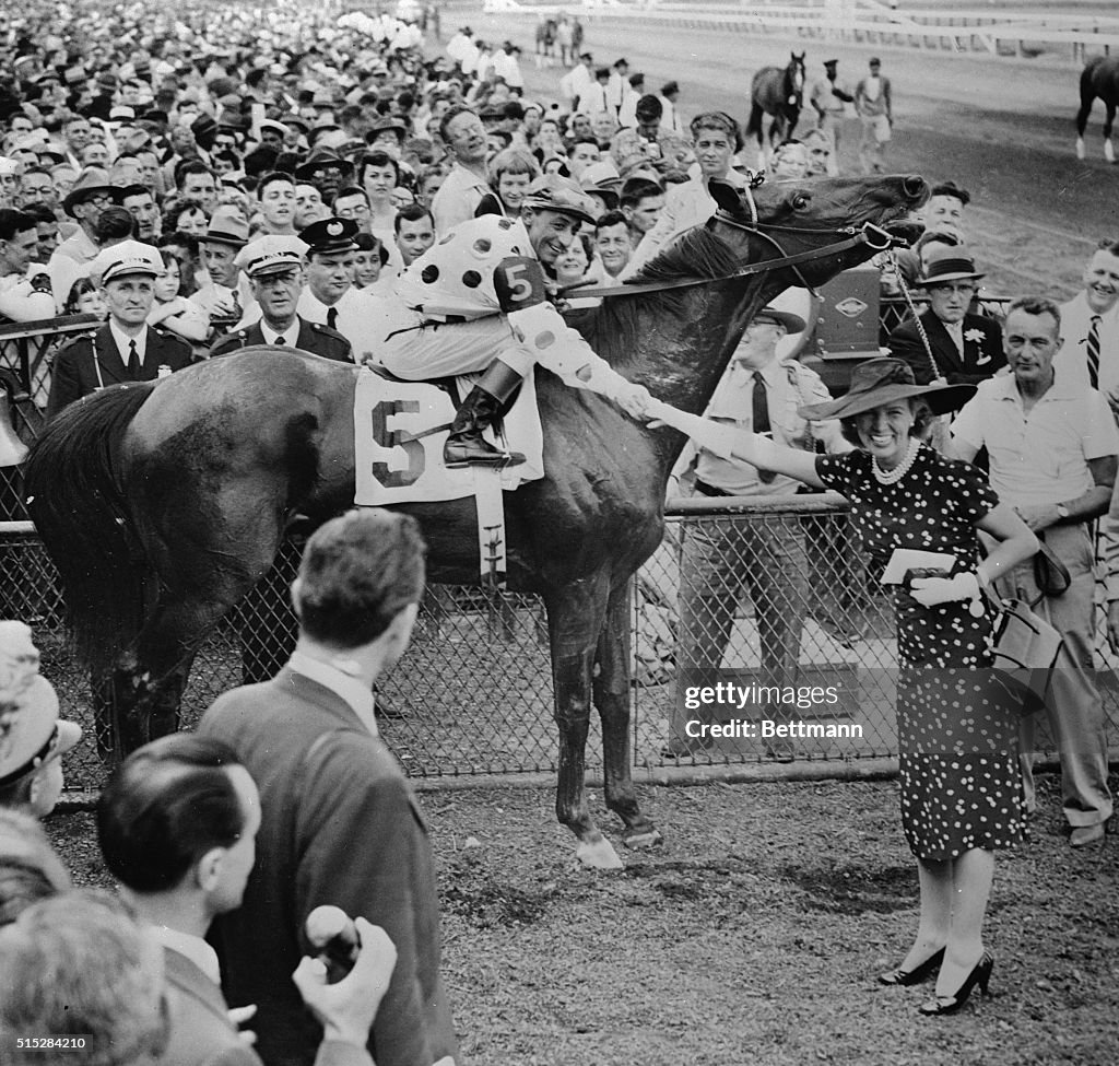 Eddie Arcaro on Nashua in Winners Circle with Crowd Behind