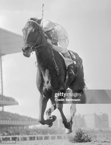 Jockey Eddie Arcaro on Bohemia Stable's Kelso, shown winning this year's mile Metropolitan Handicap under 130 pounds in a sensational stretch drive....