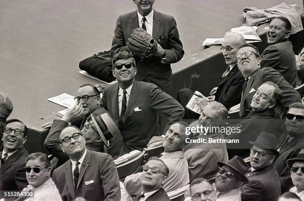 Washington, DC- DC Stadium. President Kennedy watches foul ball sail into grandstands in season's opener here 4/8. Seated beside the President is...