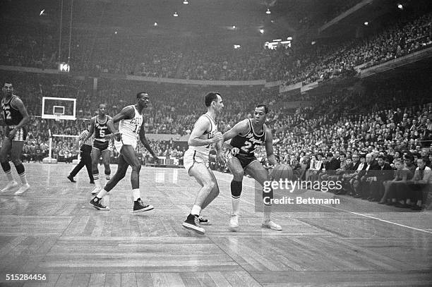 Elgin Baylor, , of the Los Angeles Lakers, tries to maneuver the ball around Bob Cousy of the Boston Celtics during second half quarter action. Los...