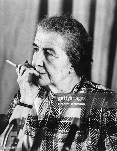 London, England- Lighted cigarette in hand, Israel's Premier Mrs. Golda Meir is completly composed as she presides over a press conference here June...