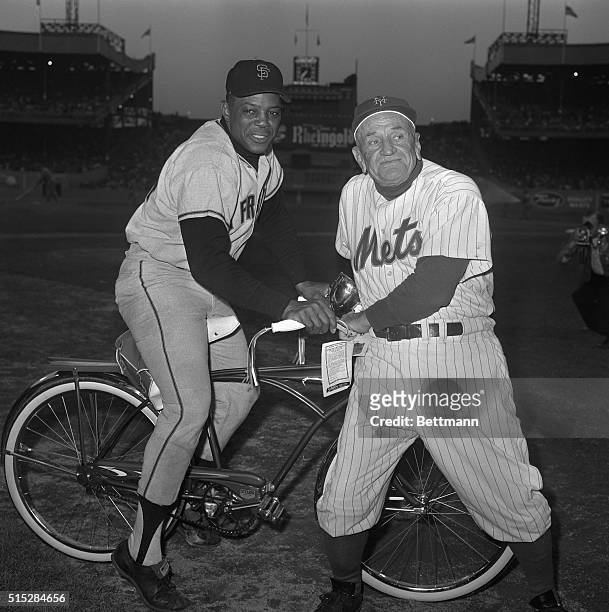 Slugging San Francisco Giant outfielder Willie Mays receives a flashy red bicycle from New York Mets manager Casey Stengel here on May 3rd, on "his"...