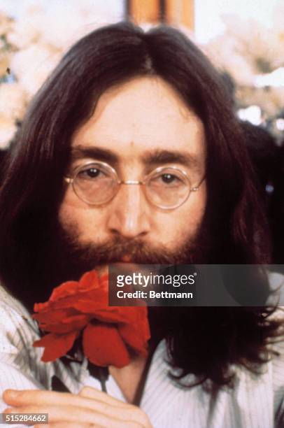 Head shot of Beatle John Lennon with rose during the "Bed-in for Peace" demonstration.
