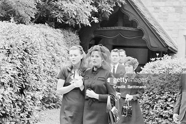 Glendale, California: Ursula Thiess, widow of actor Robert Taylor is comforted by her daughter, Manuela Thiess , as they leave the Church of the...