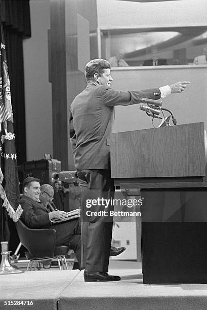 President Kennedy is caught in a jovial mood during his press conference in the State Department Auditorium today. The Chief Executive said the U.S....