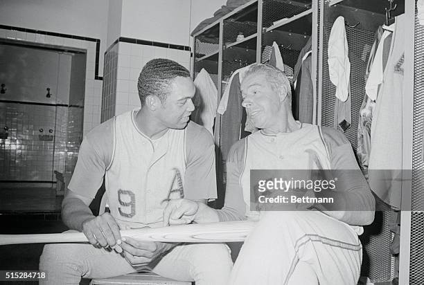 Boston: Reggie Jackson and Joe Dimaggio coach of the Oakland Athletics enjoy a light moment as Dimaggio gives some pointers to the league-leading...