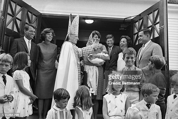 Mrs. Peter Lawford, sister of the President, holds the newest member of the Kennedy family--Christopher George, son of attorney and Mrs. Robert F....