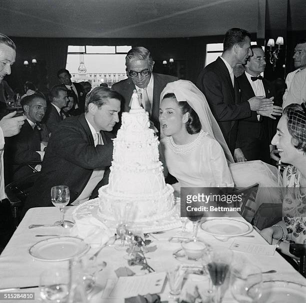 Count Hubert D'Ornano feeds a piece of wedding cake to his lovely bride, the former Isabelle Potocka, at their reception here, as ship owner...