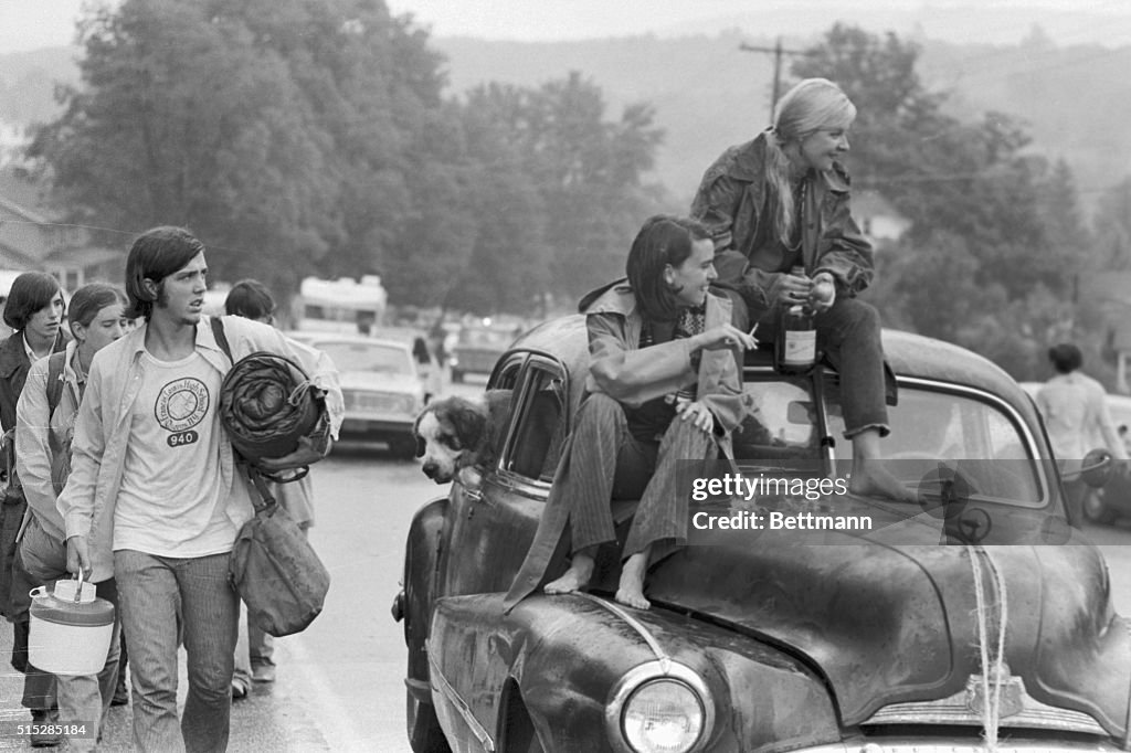 Two Women Sitting on Car Leaving Woodstock