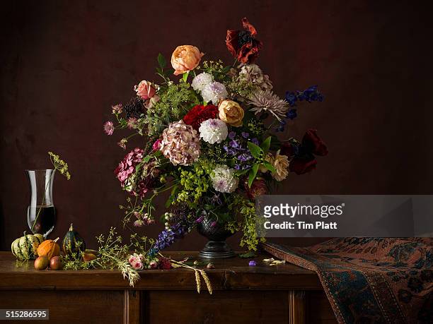 Vase of cut flowers on a wooden table.