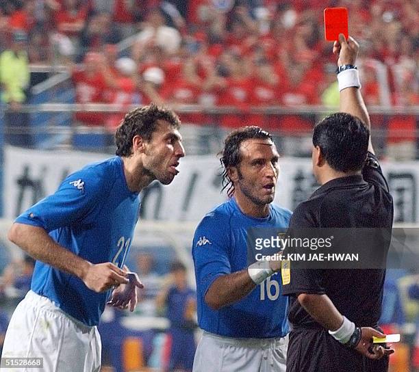 Italian forward Christian Vieri and teammate Angelo Di Livio argue with referee Byron Moreno as he gives out a red card to Italian forward Francesco...