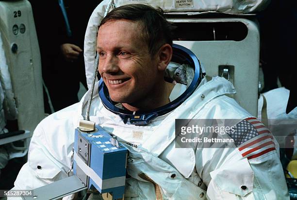 Space Center, Houston: Astronaut Neil A. Armstrong, in training for the projected Apollo 11 lunar landing mission, is being suited up for the first...
