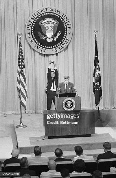 Photojournalist James Atherton photographs President Kennedy from behind while Kennedy gives a civil rights speech.