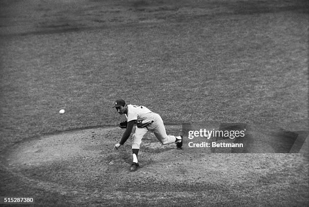 The Los Angeles Dodgers bullpen crew sits idly by as Sandy Koufax blows strike after strike past the hapless New York Mets 7/112 at the Polo Grounds....