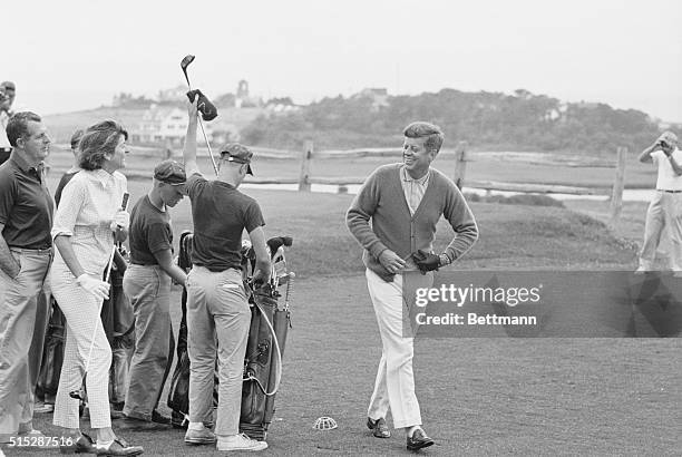 Hyannisport, Ma.: President Kennedy smiles at sister Pat, after driving off the first tee, here today. The President and Pat. Mrs. Peter Lawford,...