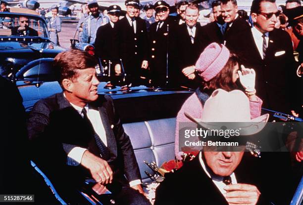 Texas Governor John Connally adjusts his tie as US President John F Kennedy & First Lady Jacqueline Kennedy settled in rear seats, prepared for...