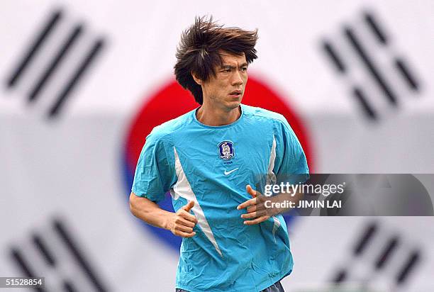 South Korean defender Hong Myung-bo trains in front of a large South Korean flag prior to the start of the quarter-final match against Spain at the...