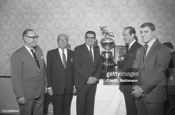 Accepting the Lambert Award for Penn State University Dec. 10, Coach Joe Paterno and football team captain Steve Smear . They flank Henry L. Lambert,...