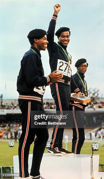 Lee Evans, Larry James, and Ron Freeman of the United States, winners of the 400 meter run in the 1968 Olympics in Mexico City, stand on the podium...