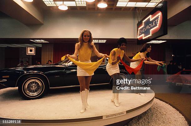 New York: Models go through their act at the Chevrolet Camaro exhibit at the International Automobile Show in the Coliseum.