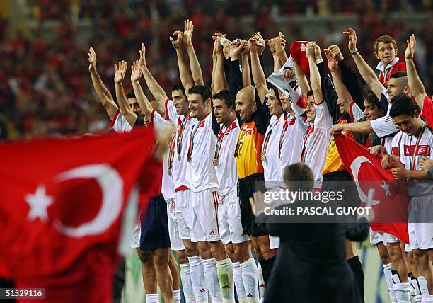 Turkey players salute the fans with medals around their necks, 29 June 2002 at the Daegu World Cup Stadium in Daegu, following the third-place...