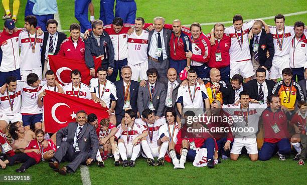The Turkish side pose with their medals and entourage following their victory over South Korea in the third place play-off match at Daegu World Cup...
