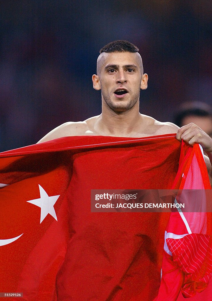 Turkish midfielder Umit Davala holds up the Turkis