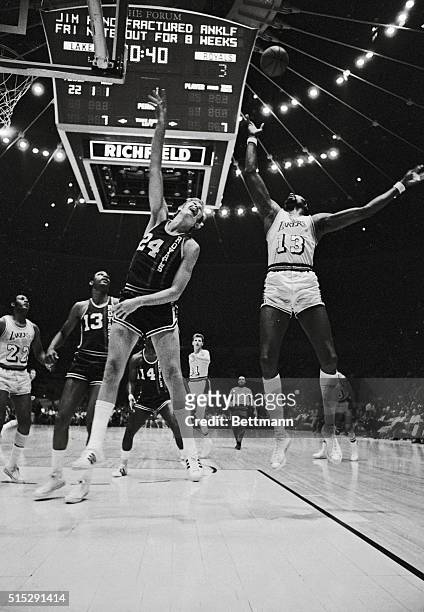 Inglewood, California: Los Angeles Lakers Wilt Chamberlain and Cincinnati Royals Connie Dierking go high in the air for ball during first quarter of...