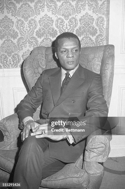 Outfielder Curt Flood relaxes in the lobby of the Warwick Hotel after he filed a $1 million anti-trust suit against baseball commissioner Bowie Kuhn,...