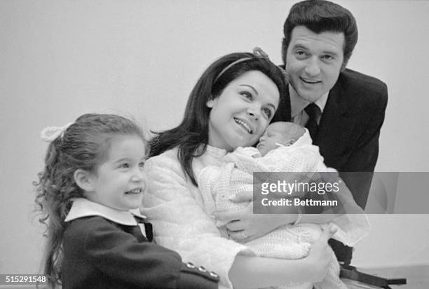 Actress Annette Funicello cuddles her newborn son, Jack, Jr., at St. Joseph's Hospital. Looking on is the proud father, Jack Gilardi, and their...