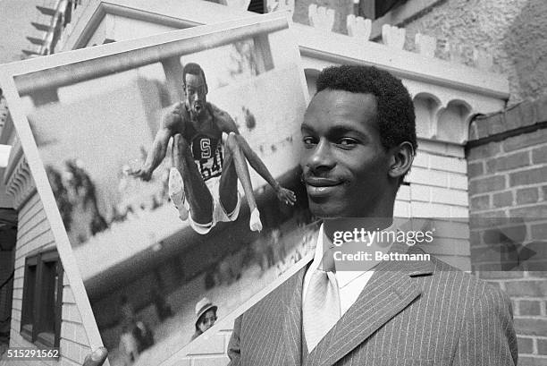 Bob Beamon, of El Paso, Texas, Olympic Gold Medal Winner for his record shattering 29-foot, 2 1/2-inch long jump in Mexico City two years ago, hoists...