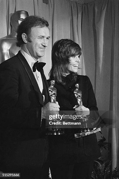The best actor and actress for 1971, Gene Hackman and Jane Fonda, hold on tightly to their just presented Oscars at the 44th annual Academy Awards at...