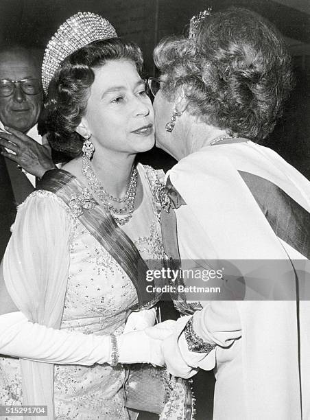 London: Queen Juliana of the Netherlands greets Queen Elizabeth II at Carpenters Hall 4/13. Queen Elizabeth had just arrived to attend a banquet...