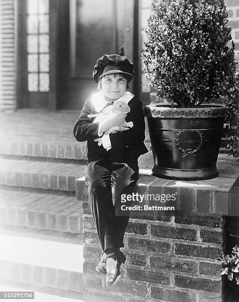 "The Kid and his pet"...Jackie Coogan, the juvenile film star, with his pet bunny, and his Fauntleroy suit, and cap to match, not forgetting the...