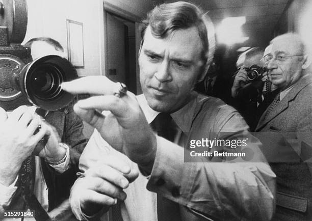 The Detroit Tiger's pitching star Denny McLain shies away from photographers as he leaves the office of baseball commissioner Bowie Kuhn. McLain was...