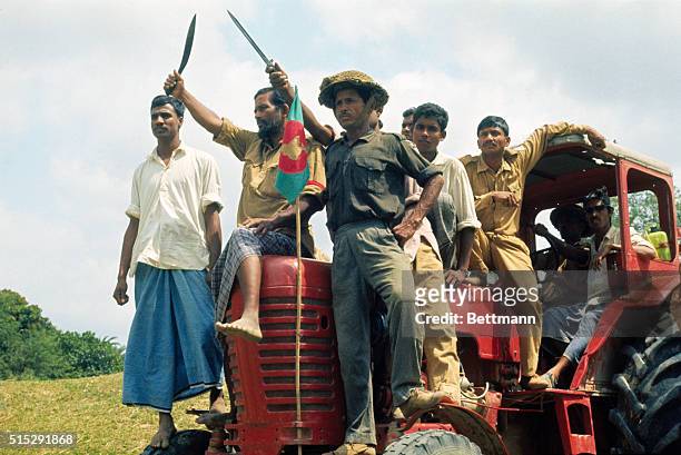 Pro-independence Mukti Bahini forces, perched atop a tractor at the Meshila Checkpost, sing their battle song during the Bangladesh War of...